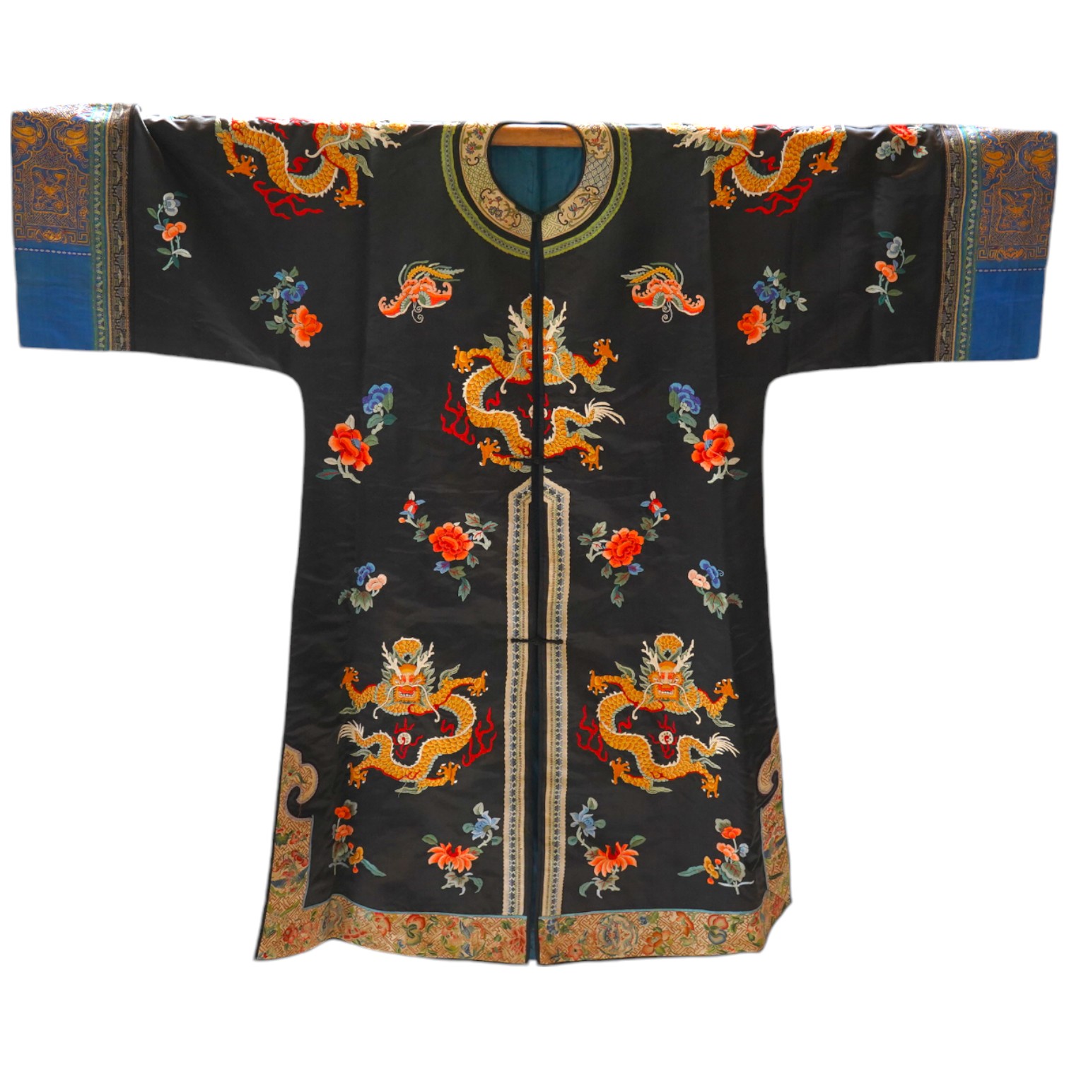 An early 20th century Chinese blue satin silk embroidered dragon robe, embroidered with five claw dragon symbols with flaming pearls, surrounded by bats and flower motifs, with gold thread embroidered dragon sleeve bands